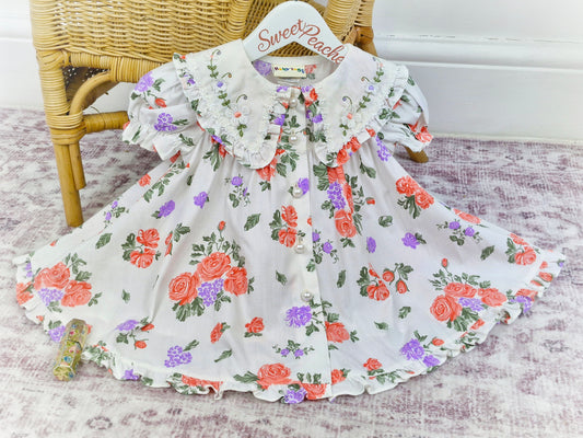 18 months. White dress from Baby Togs with floral print, large embroidered collar and pearl style buttons