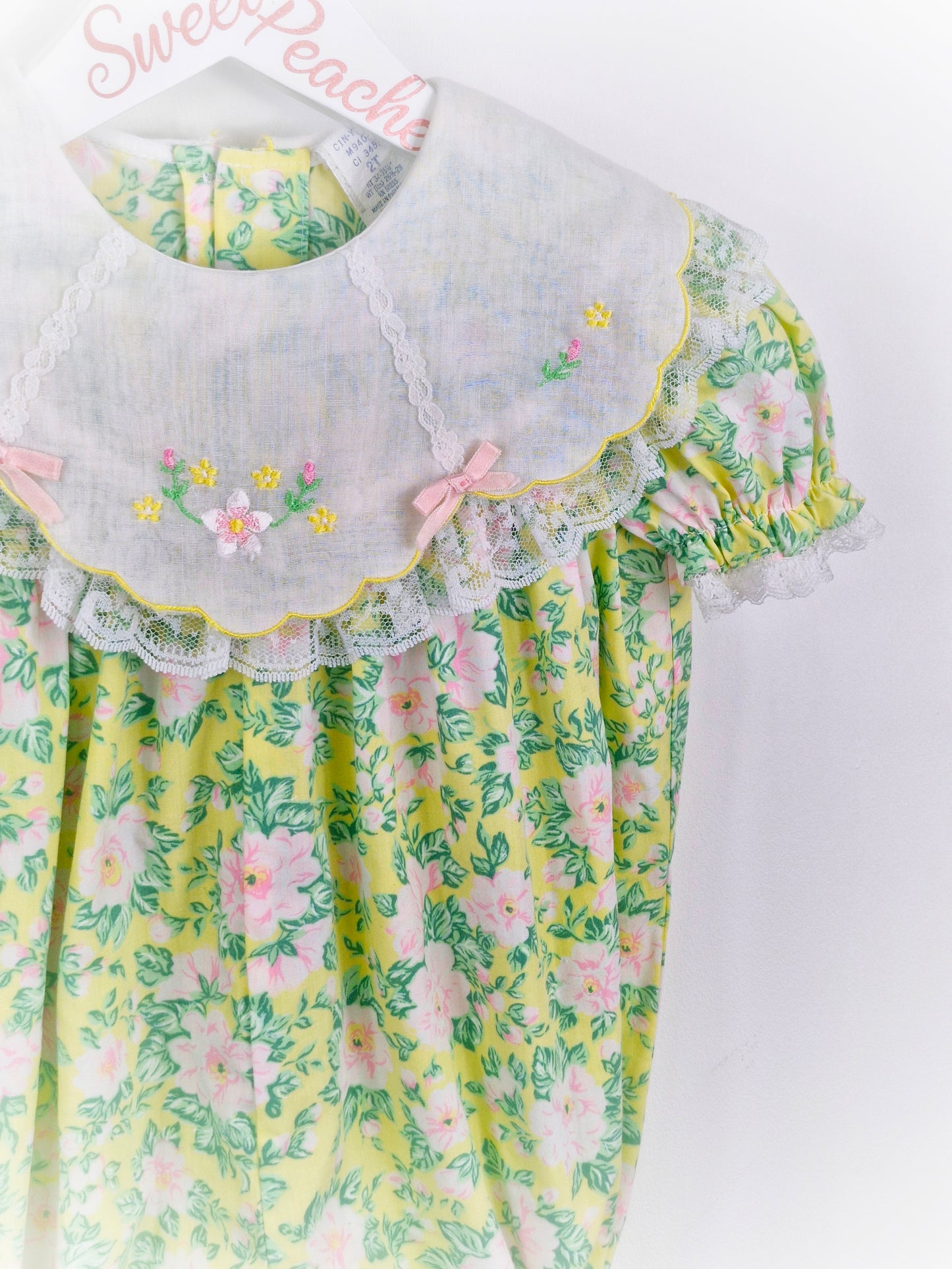 12-24 months. Floral romper with embroidered bib