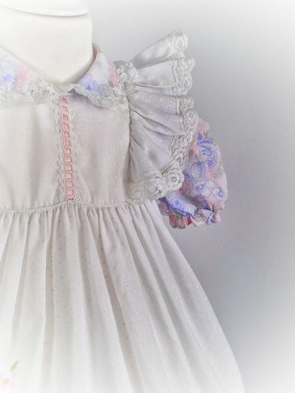 3 years. White dress with pastel flutter sleeves and hem. Cherry applique and lace details