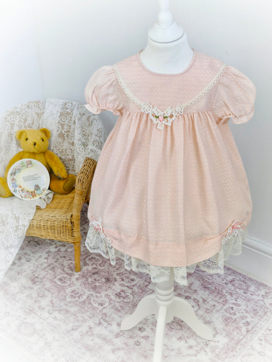 3-4 years. Light pink vintage Jolene with lace hem and delicate lace applique with pink ribbon rose