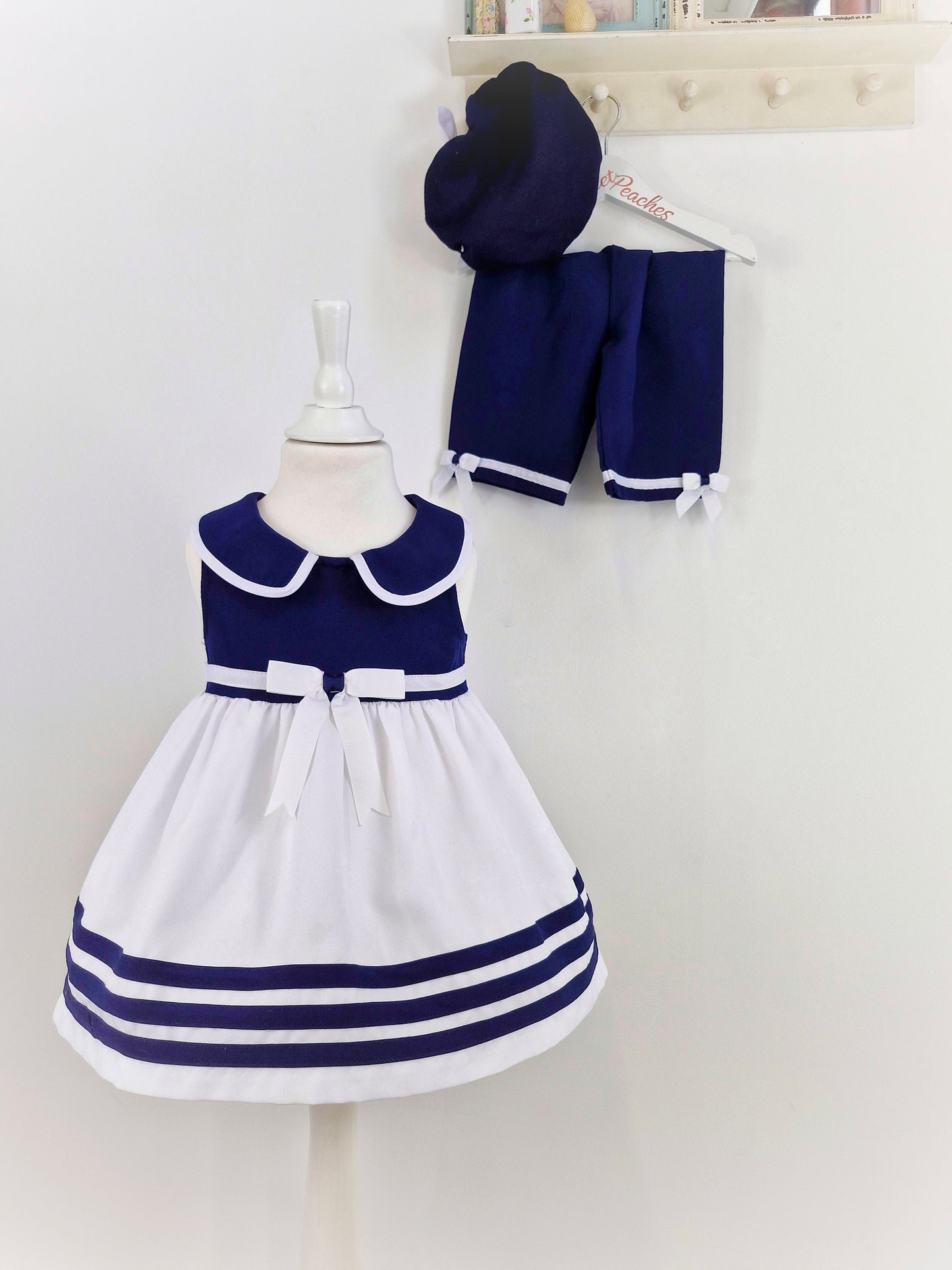 2-3 years. 3 piece set. Navy and white dress, shorts and beret