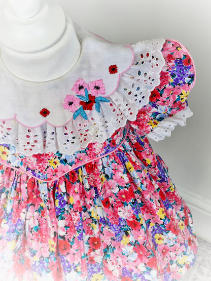 2 years. Ruth of Carolina pink floral vintage dress with white bib embroidered with flowers and lace details