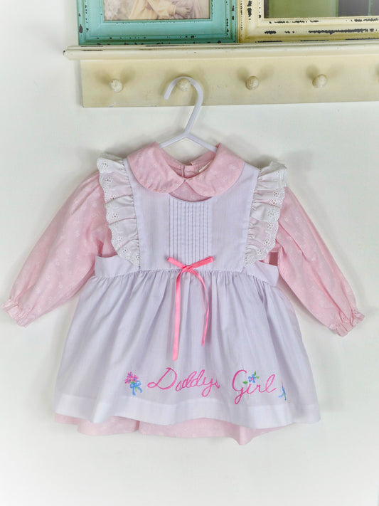 12-18 months. Two piece, pink long sleeve dress with white pinny, embroidered "Daddy's Girl"