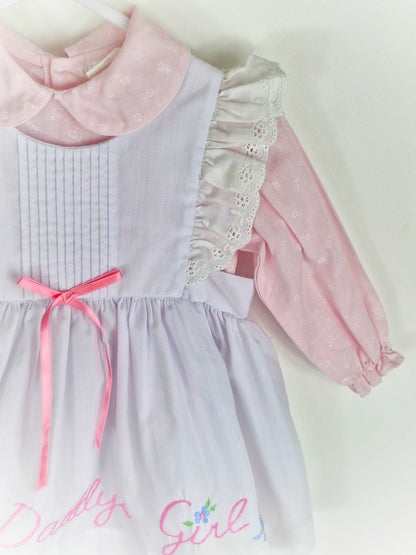 12-18 months. Two piece, pink long sleeve dress with white pinny, embroidered "Daddy's Girl"