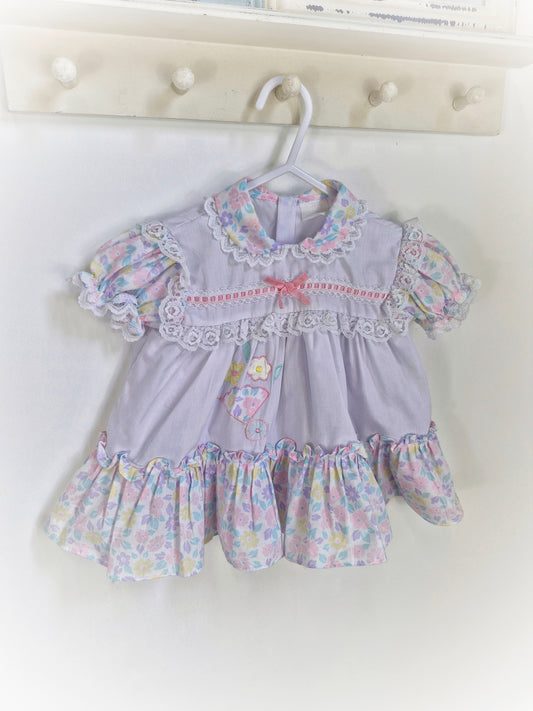 9-12 months. White frilly vintage dress with pastel flowers, ribbon and lace