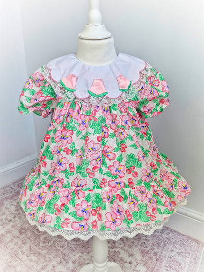 2 years. Strawberry and floral dress with white bib and roses. Lace detail on bib and hem
