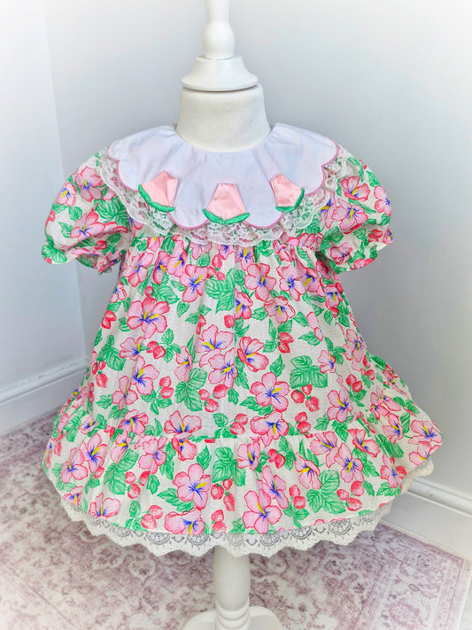 2 years. Strawberry and floral dress with white bib and roses. Lace detail on bib and hem