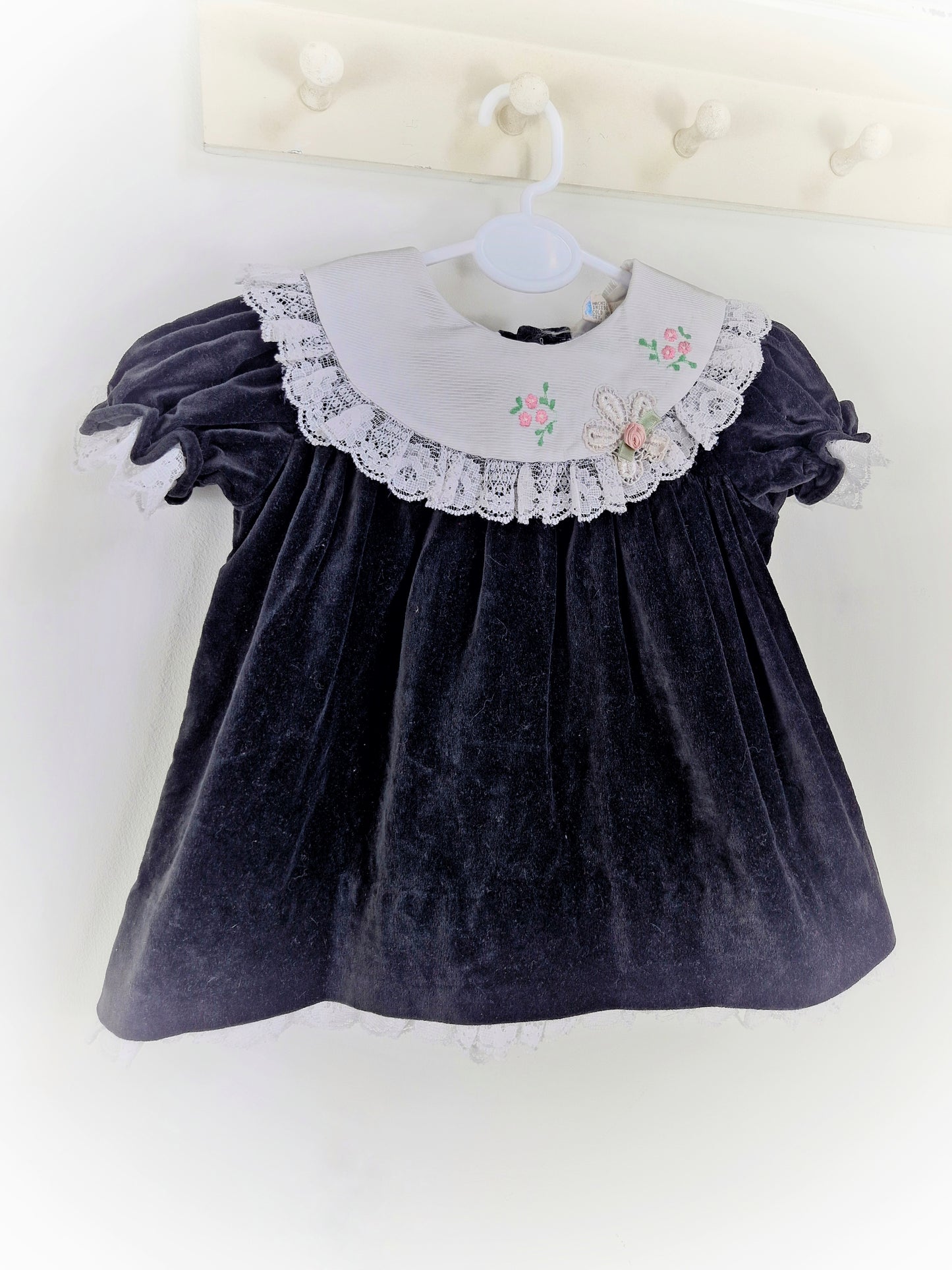 9-12 months. Black velvet vintage dress with white embroidered bib and lace hem