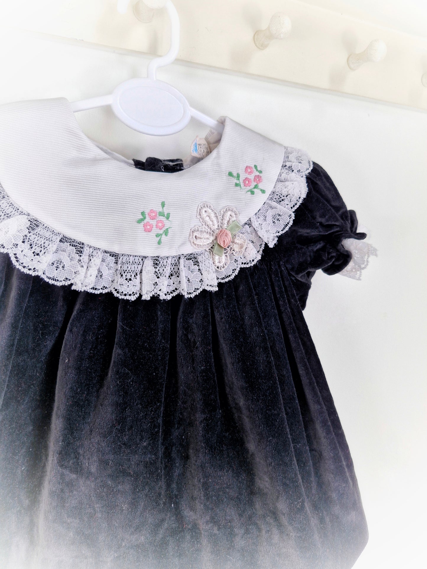 9-12 months. Black velvet vintage dress with white embroidered bib and lace hem