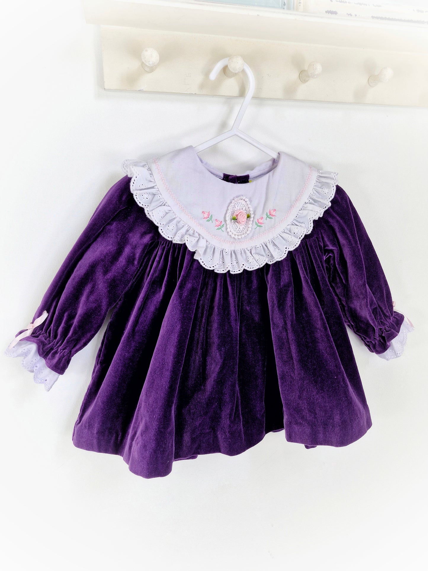 9-12 months. Purple vintage velvet long sleeve dress with white bib and rose details