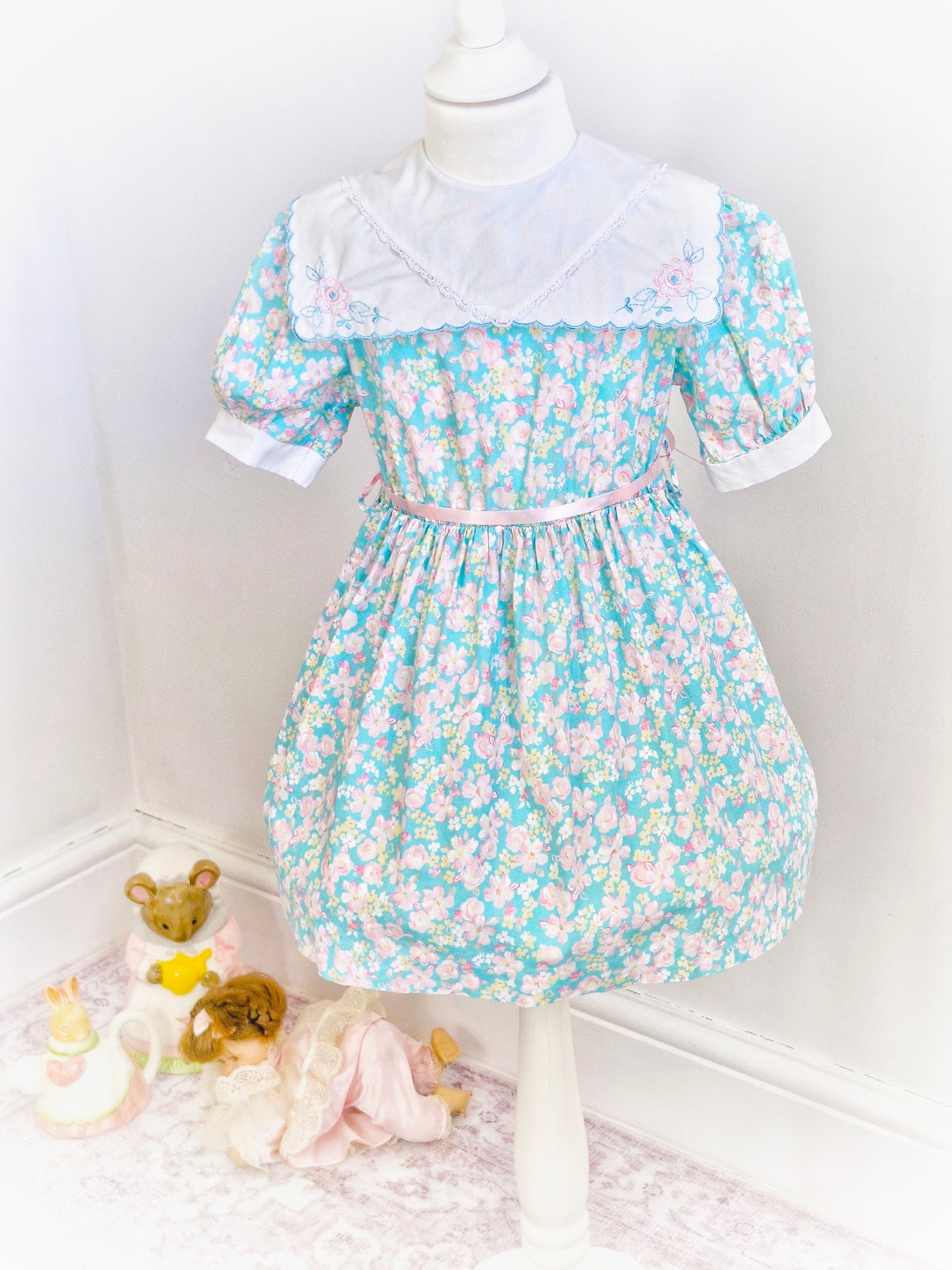4 years. Blue floral dress with white scalloped edge bib, embroidered with flowers. JC Penney