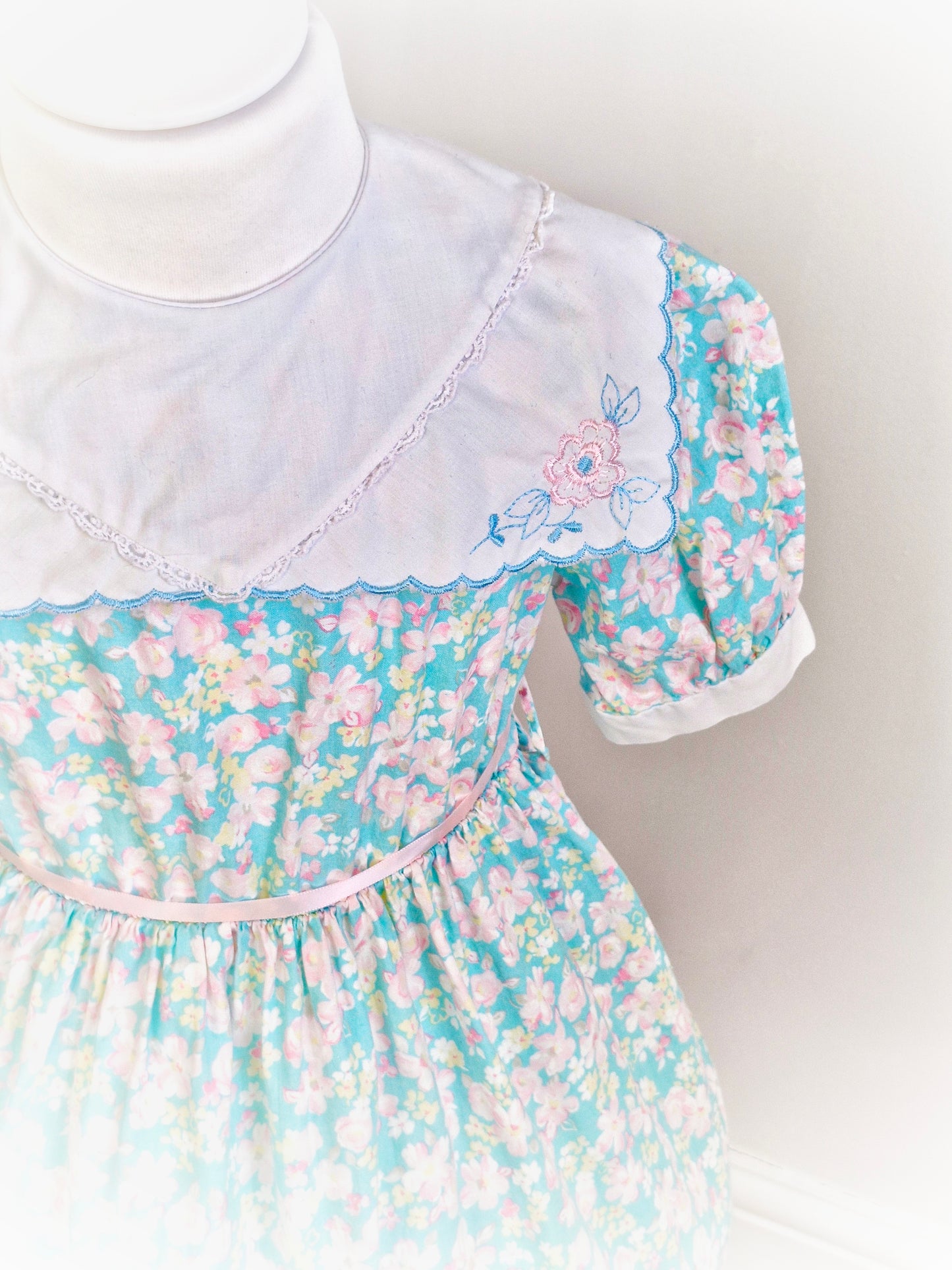 4 years. Blue floral dress with white scalloped edge bib, embroidered with flowers. JC Penney