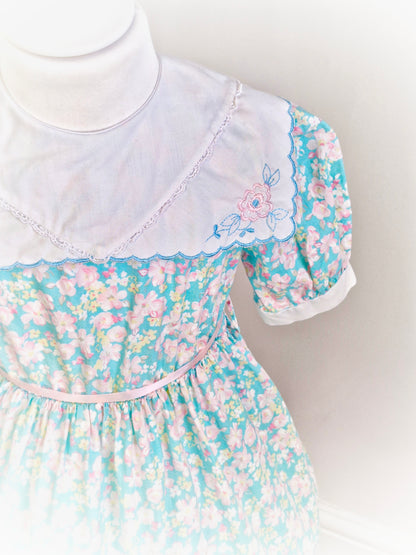 4 years. Blue floral dress with white scalloped edge bib, embroidered with flowers. JC Penney