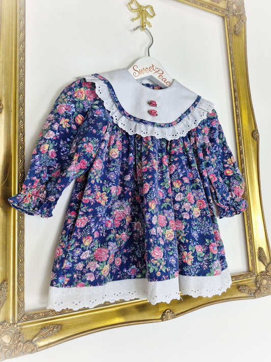 12-18 months. Navy floral vintage dress from BB Club with white broderie anglais bib and hem