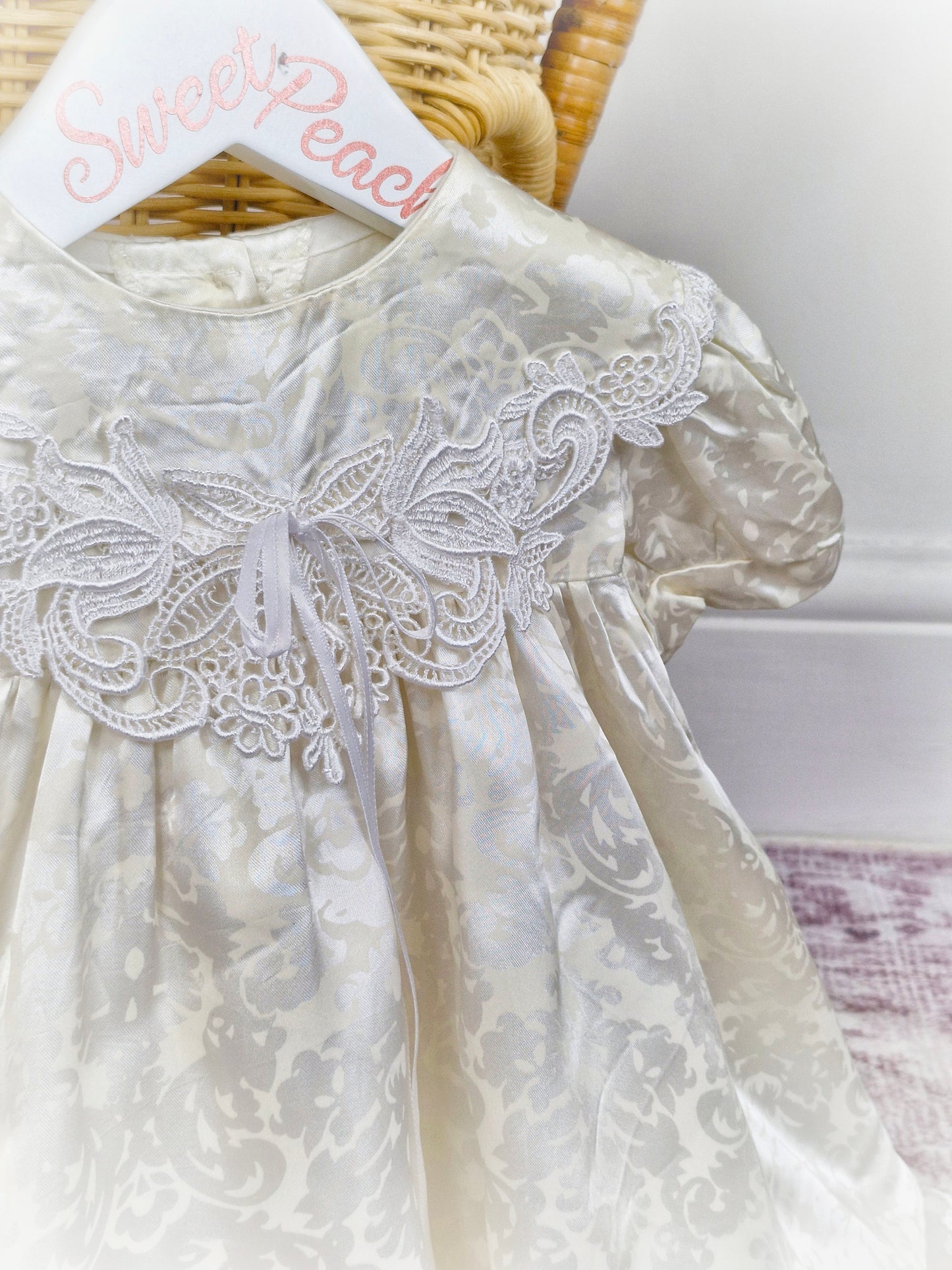 18-24 months. Off-white satin dress with floral patterns and lace details