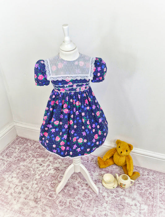 3-4 years. Navy Polly Flinders with flowers, lace and polka dots
