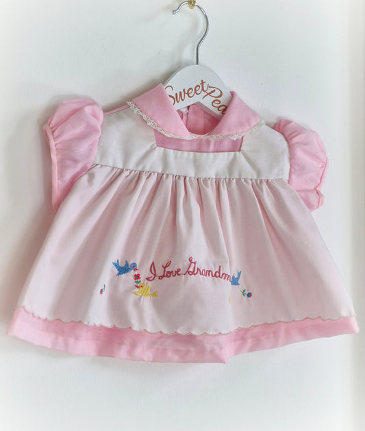 0-6 months. Pink and white vintage dress with embroidered "I love Grandma"
