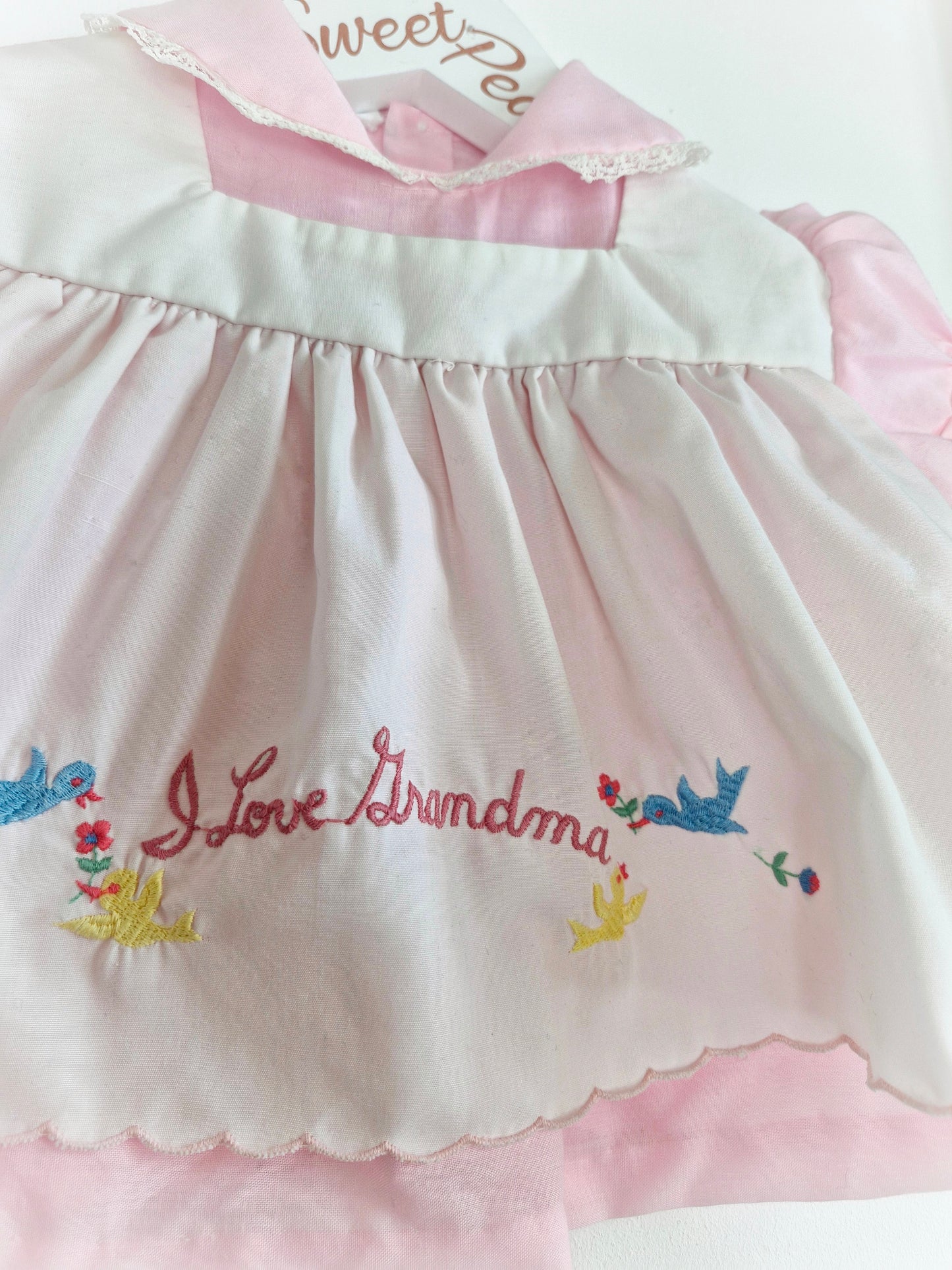 0-6 months. Pink and white vintage dress with embroidered "I love Grandma"