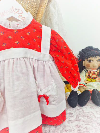 12 months. Long sleeve red floral vintage dress with white pinny