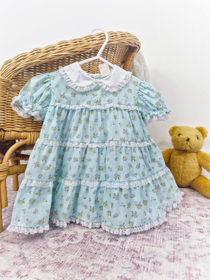 12-18 months. Light blue vintage floral dress with lace details