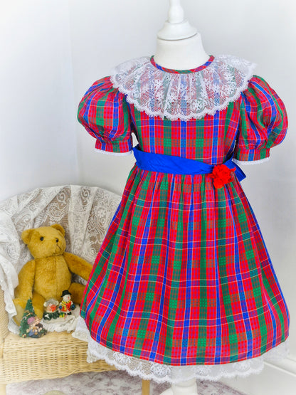 6 years. Red, blue and green Youngland tartan dress with white lace bib and hem