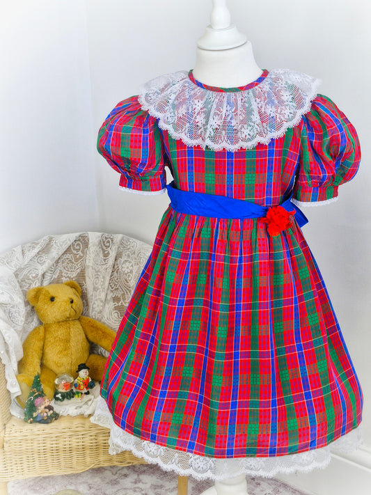 6 years. Red, blue and green Youngland tartan dress with white lace bib and hem