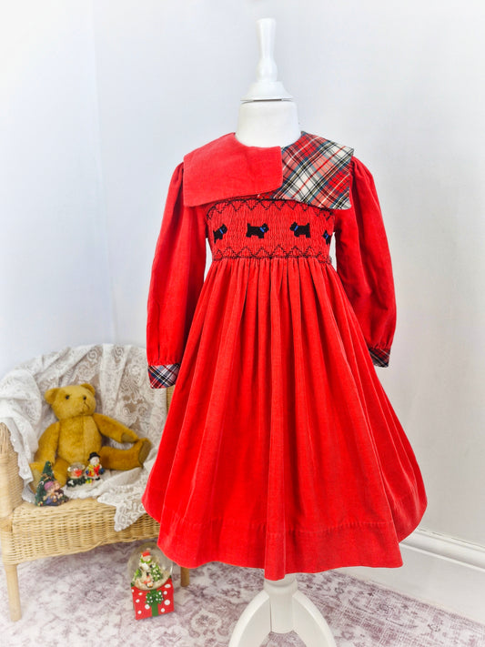 5-6 years. Heirlooms by Polly Flinders. Red corduroy dress with tartan bib and scotty dog smocking