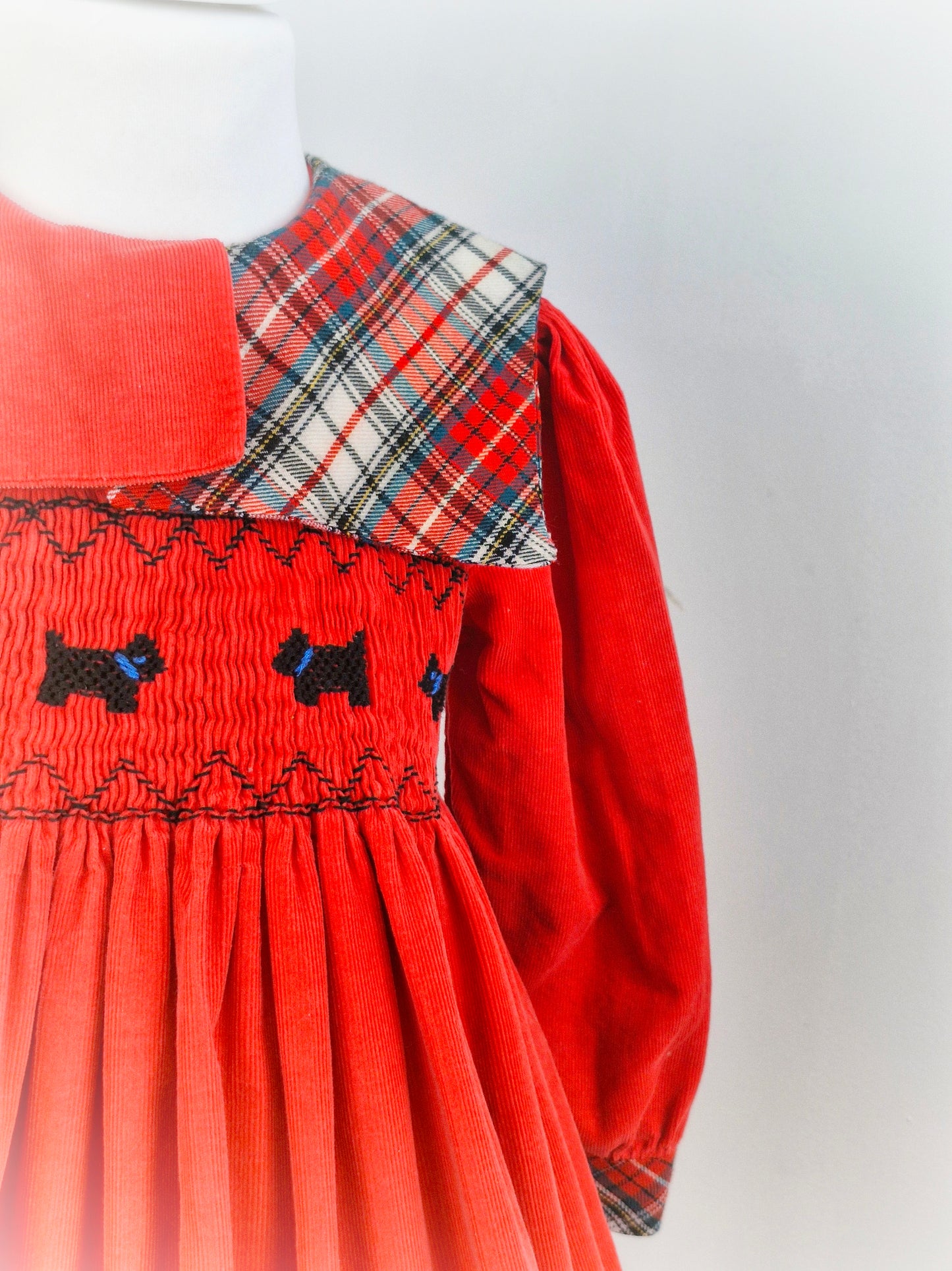 5-6 years. Heirlooms by Polly Flinders. Red corduroy dress with tartan bib and scotty dog smocking