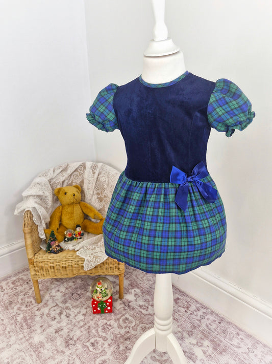 2 years. Vintage Adams dress, navy velour top and tartan skirt and sleeves with blue ribbon bow.