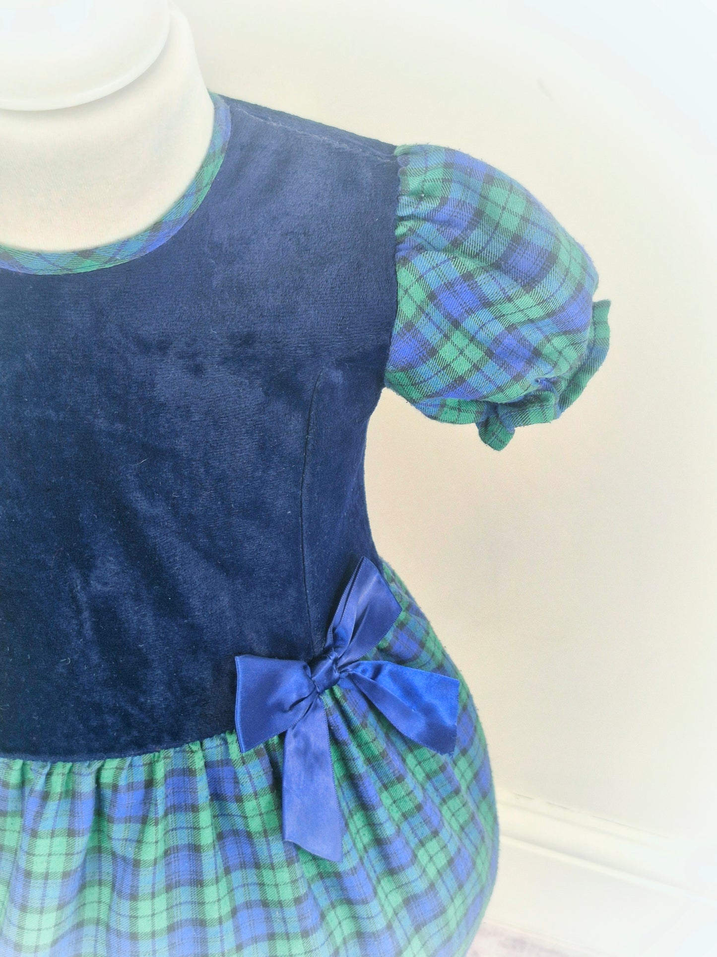 2 years. Vintage Adams dress, navy velour top and tartan skirt and sleeves with blue ribbon bow.