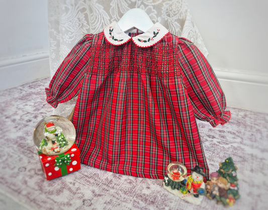 12-18 months. Red tartan dress from Koala Baby with white collar embroidered with holly leaves and smocking