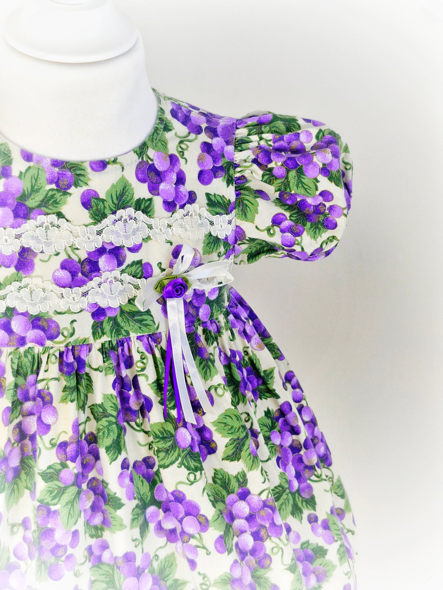 2 years. Vintage Jessica Ann, purple grapes with green leaves. Lace and ribbon details