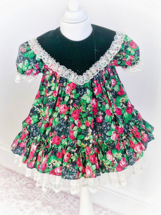 2-3 years. Vintage Jolene, black with red roses and green leaves. Minor faults on bib*