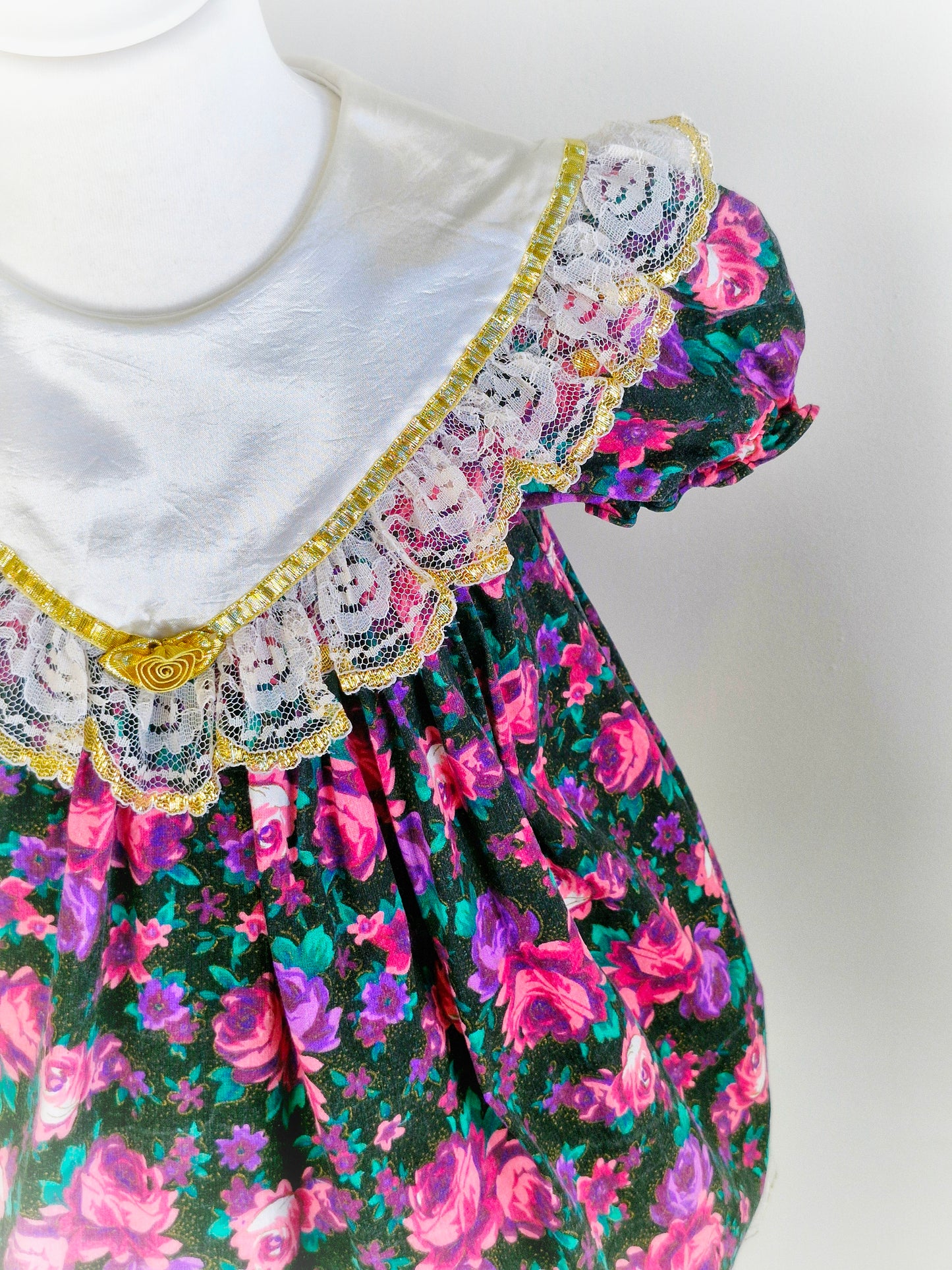 3-4 years. Vintage Jolene, black dress with pink and purple flowers, white satin bib with lace and gold trim