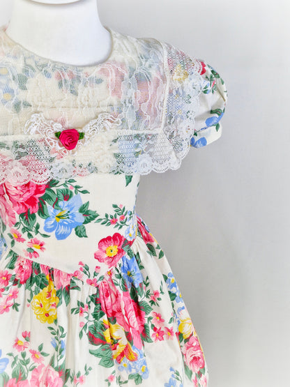 6-7 years. Beautiful floral vintage dress by Picture Perfect with lace bib and hem