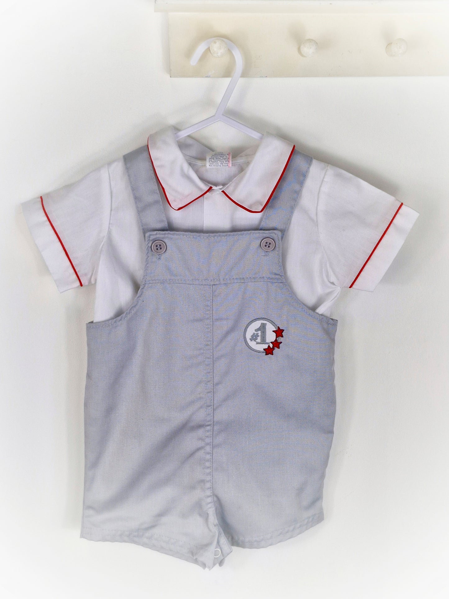 18-24 months. Two piece set, white shirt with red trim and grey dungarees