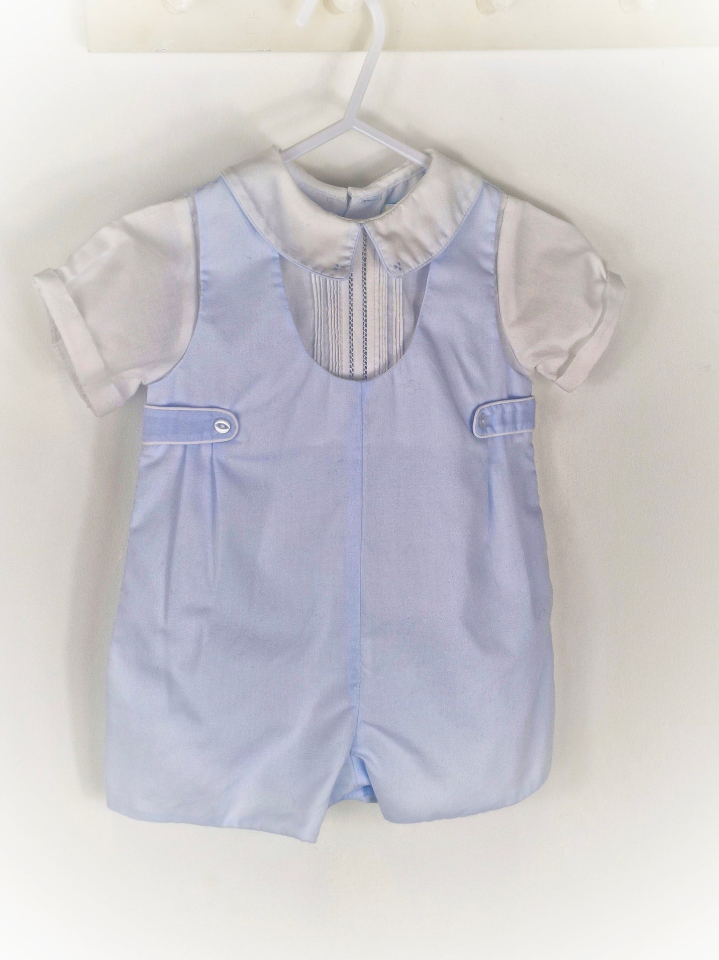 9 months. Blue and white collared romper from Petit Ami
