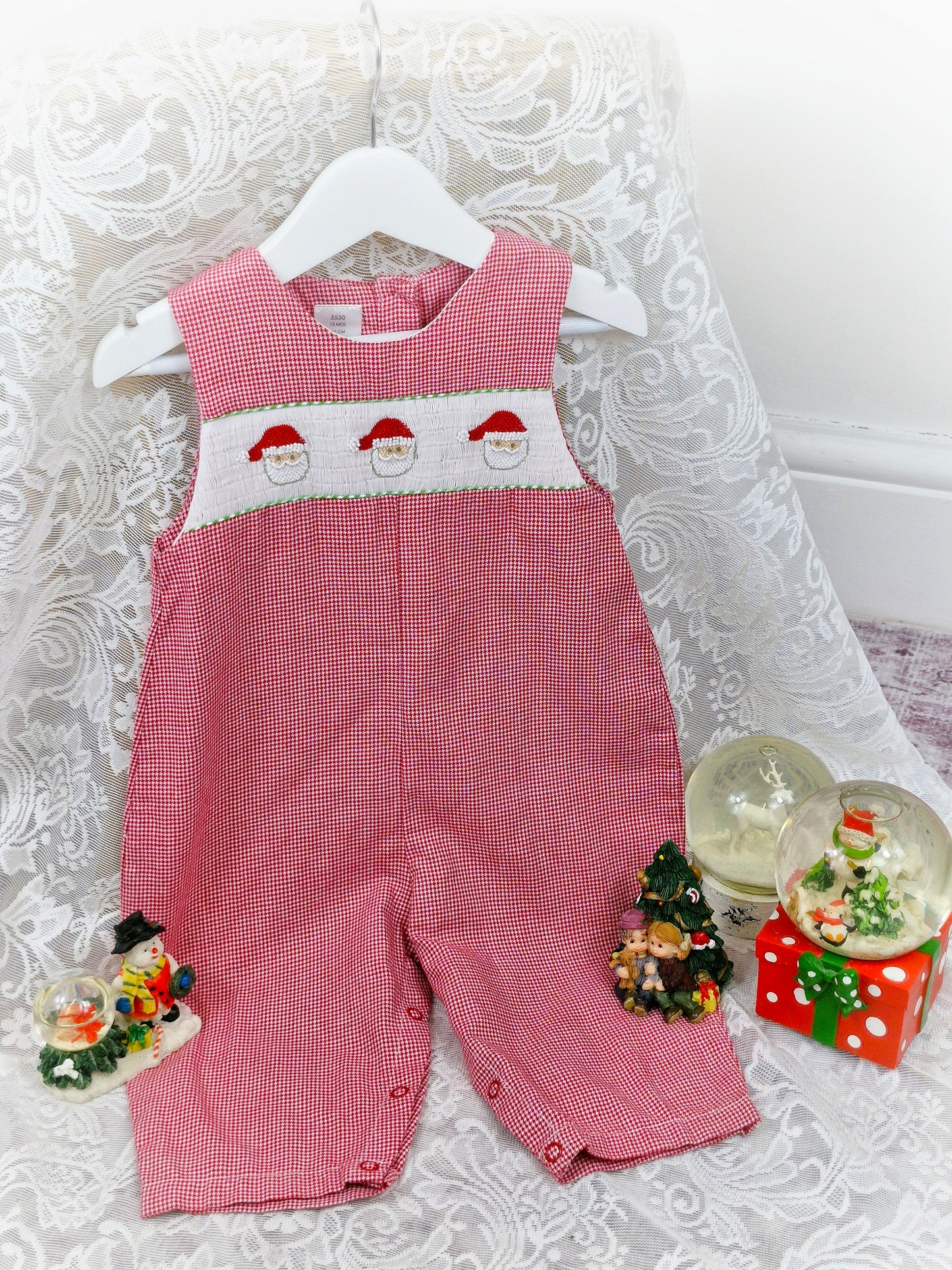 18 months. Red and white gingham romper with white smocking and embroidered Santa faces