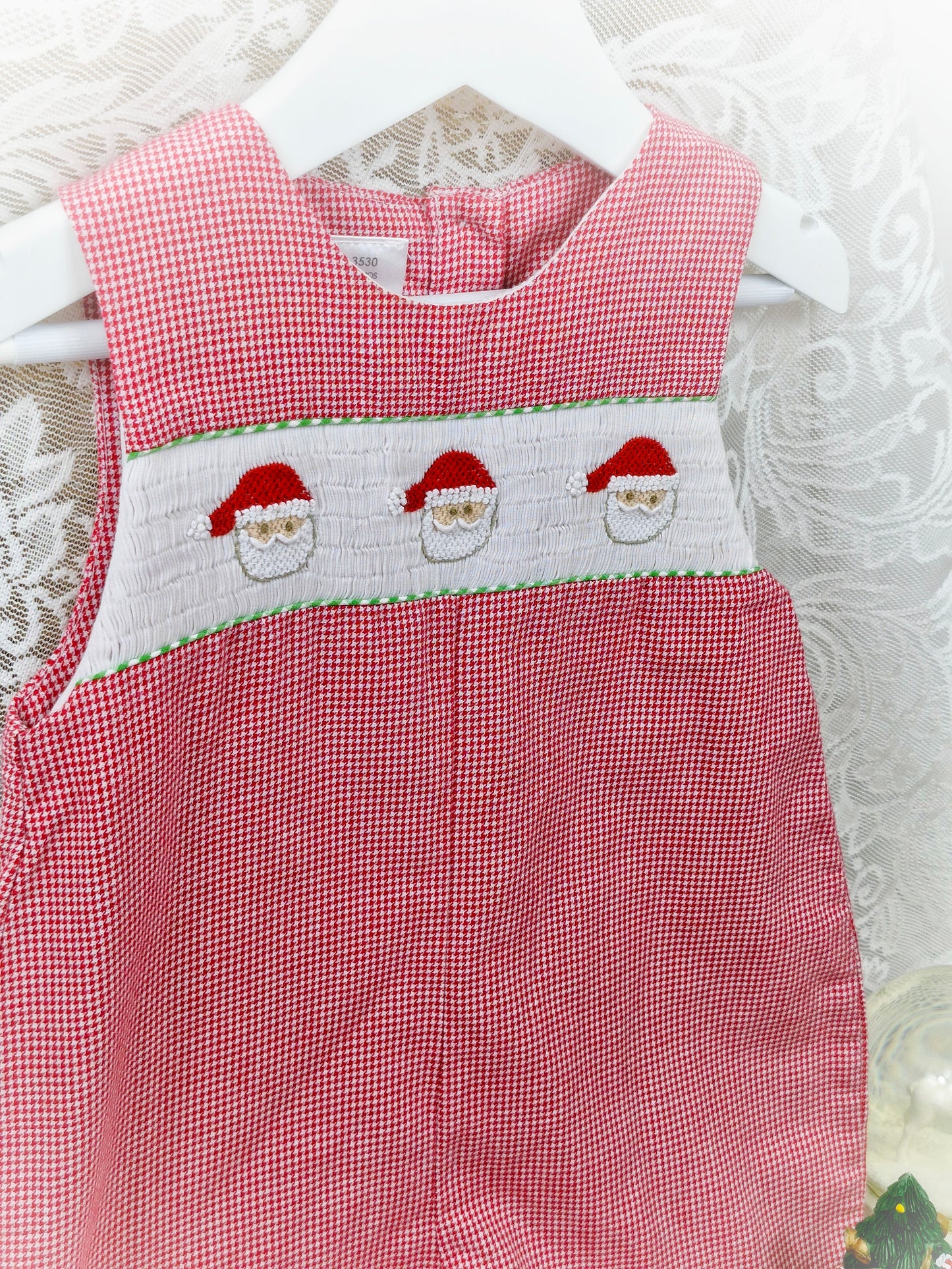 18 months. Red and white gingham romper with white smocking and embroidered Santa faces