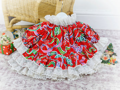 9-12 months. Brightly coloured handmade festive dress with puffed sleeves and a white lace trim