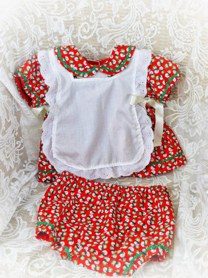 0-3 months. 3 piece set; dress, bloomers and pinny. Red with snowman print. Handmade.
