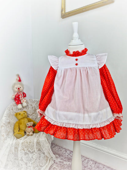 18-24 months. Red polka dot dress with white flutter sleeved pinny