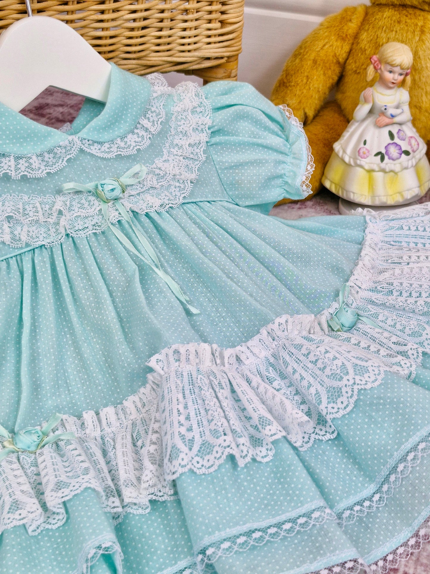 9-12 months. Vintage Petit Jouet, mint dress with white lace and rosettes