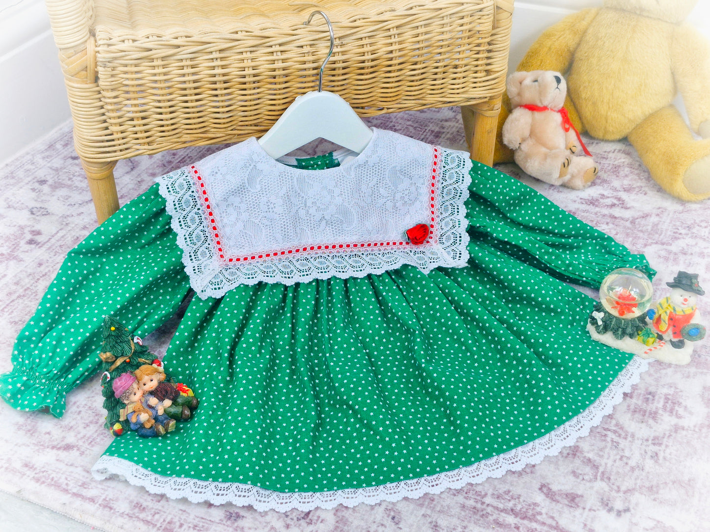 9-12 months. Green vintage Bryan with star print, white lace bib and red details