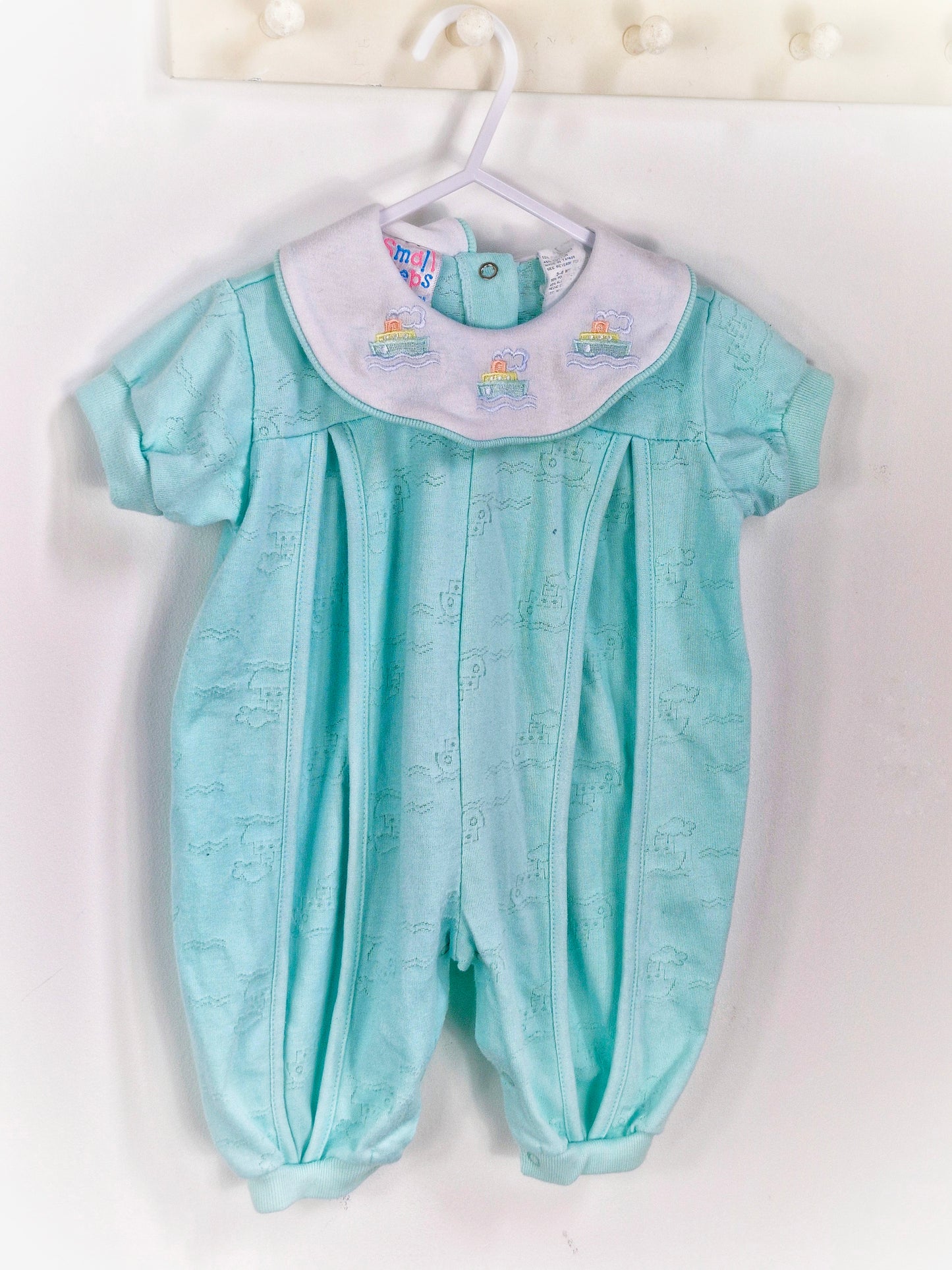 6-9 months. Mint romper with embroidered boats on collar. Small steps