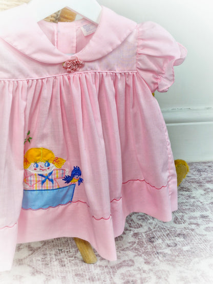 9-12 months. Sweet pink vintage dress with girl and bird in boat
