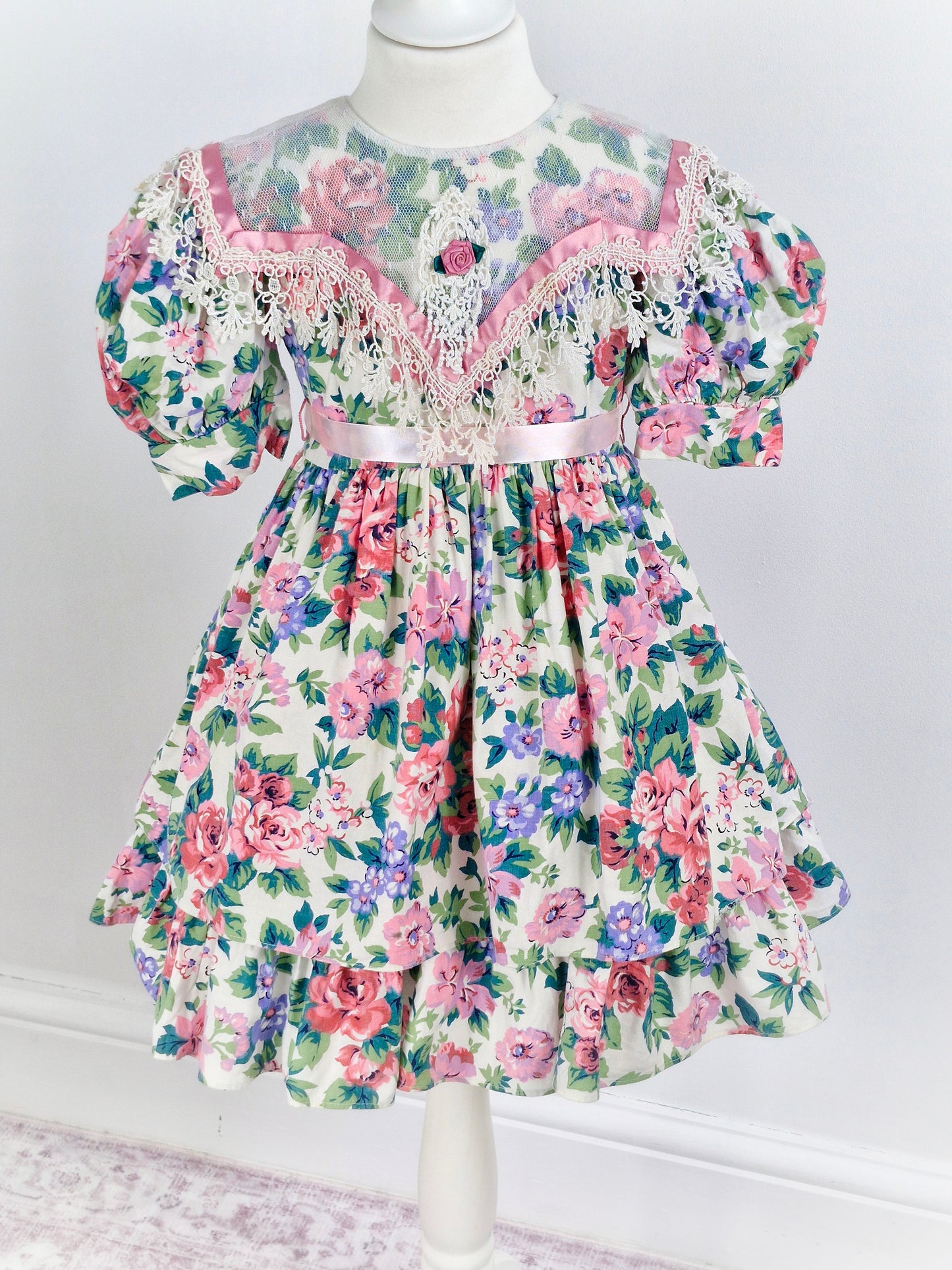 4-5 years. Vintage Jinelle, pastel floral print. Sheer bib, pink ribbon and rosette