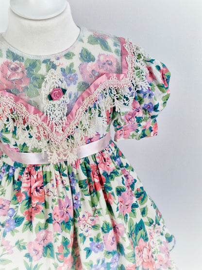 4-5 years. Vintage Jinelle, pastel floral print. Sheer bib, pink ribbon and rosette