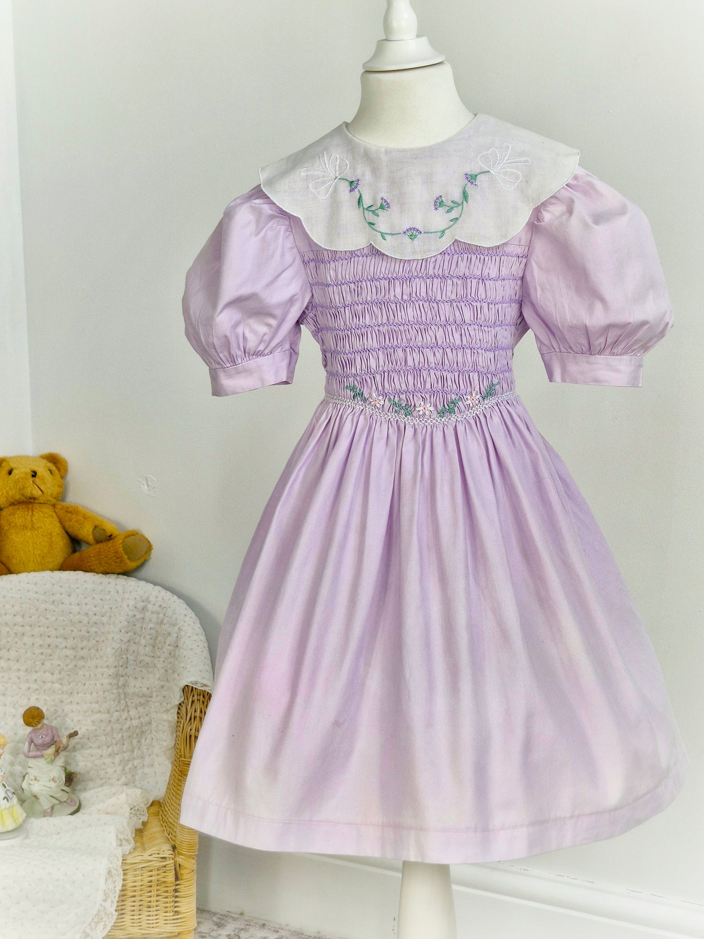 5-6 years. Polly Flinders, vintage lilac smock dress with white bib embroidered with delicate flowers and puff sleeves