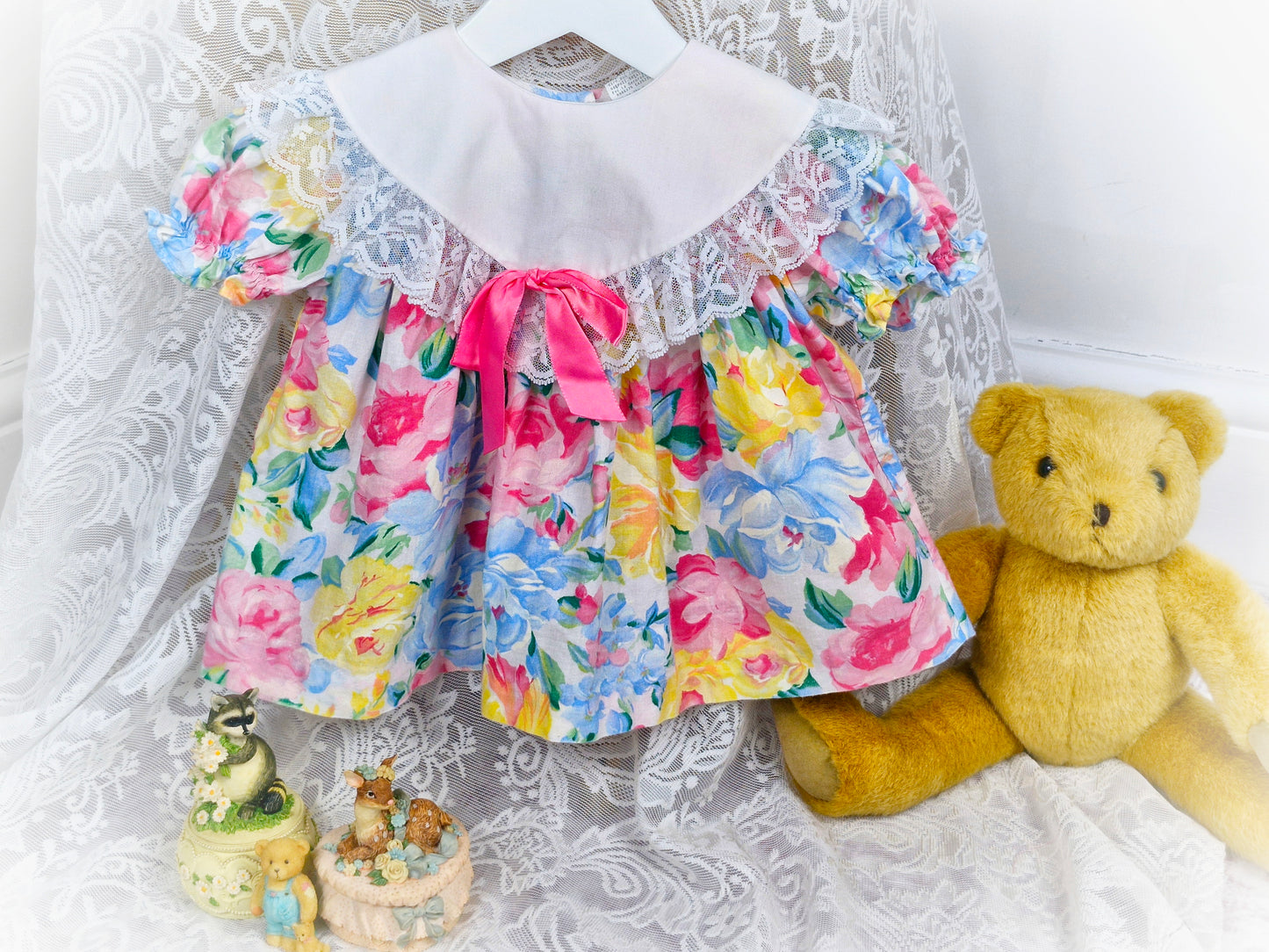 6-9 months. Pastel floral vintage dress with white bib, lace trim and pink ribbon bow
